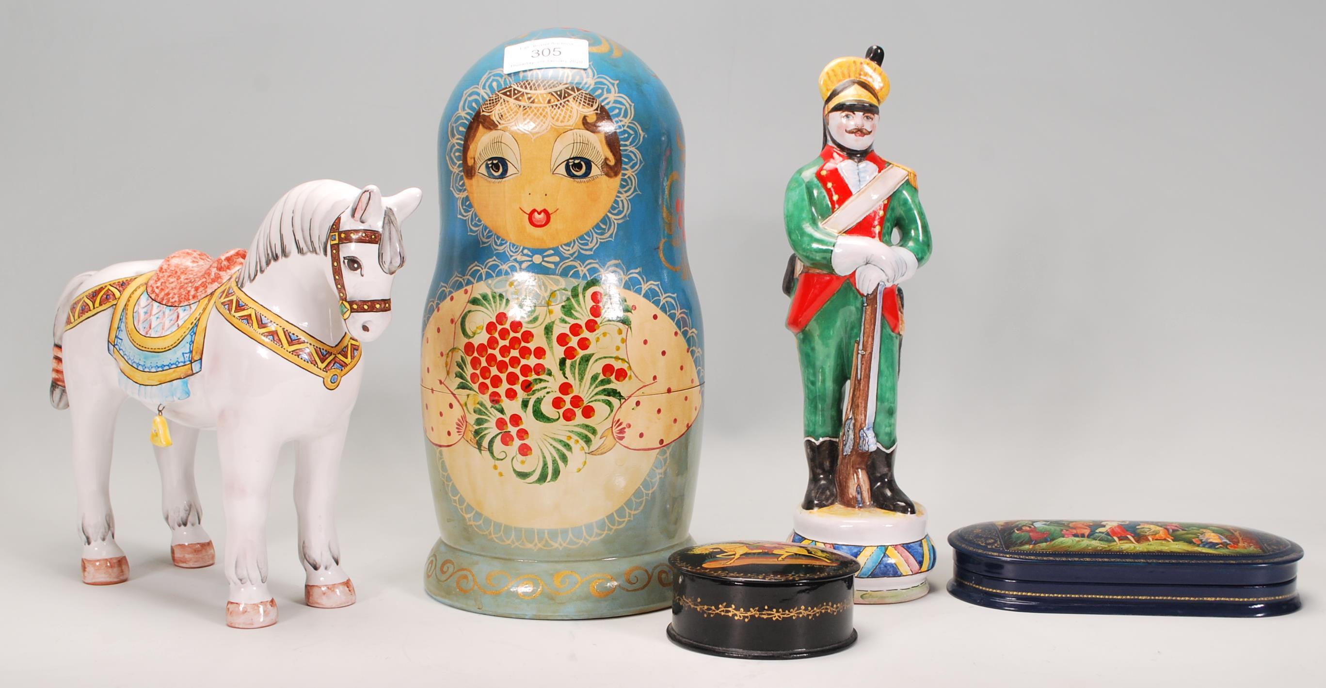 A collection of Russian ornaments to include a large set of russian dolls beung hand painted with