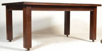 An early 20th century solid oak and mahogany large refectory dining table. Raised on squared legs