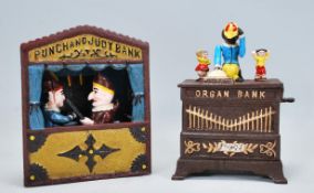 Two vintage style novelty mechanical money banks to include a Punch and Judy puppet theatre bank and