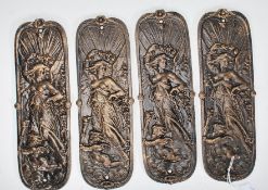 A group of four cast iron door furniture finger plates having embossed angel and cherub decoration