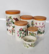A group of five Portmeirion Botanic Garden storage jars having wooden covers and a egg cup in the