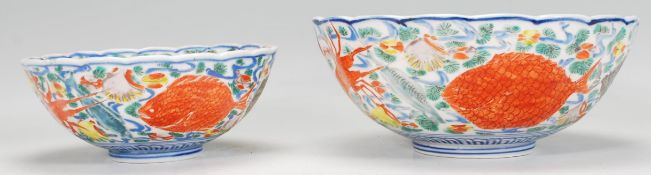 A pair of graduating 20th Century Chinese centrepiece bowls having scalloped rims with round
