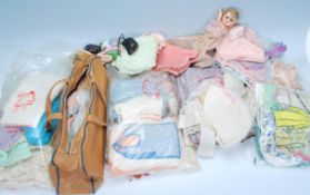 A collection of vintage dolls woolen clothing, shoes etc together with accessories, dolls