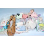 A collection of vintage dolls woolen clothing, shoes etc together with accessories, dolls