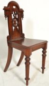 A 19th Century Victorian mahogany hall chair, with pierced back and scrolling decoration, raised