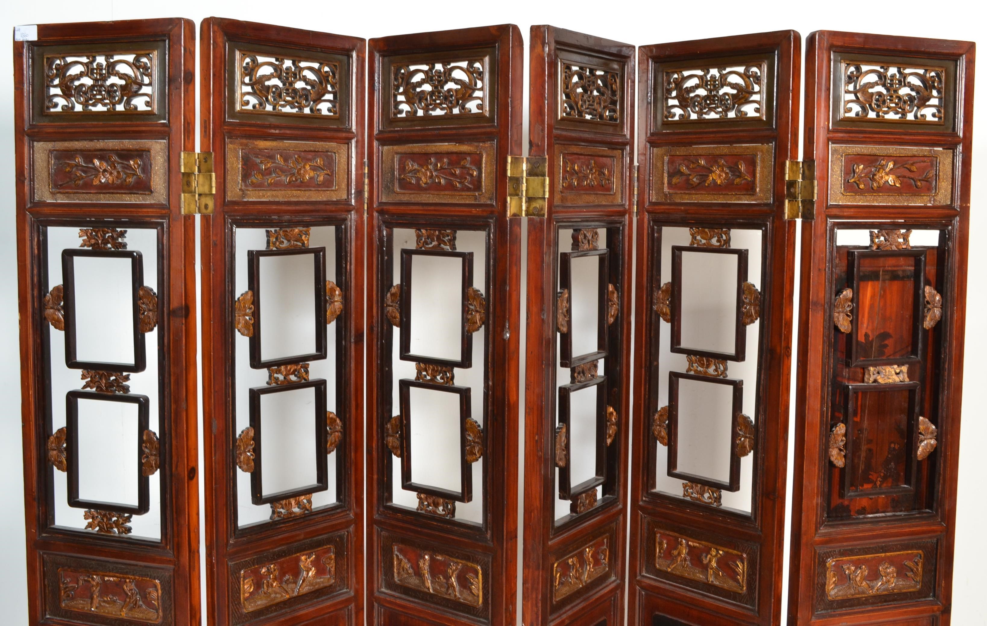 A large 20th Century six fold Chinese lacquered pine screen having scroll fret work panel atop - Image 2 of 4