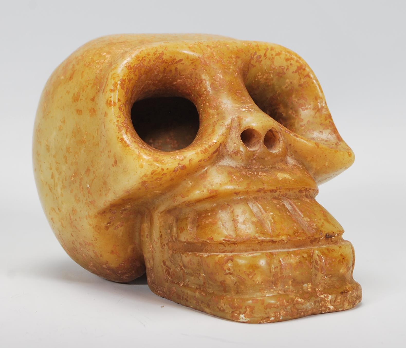 A 20th Century carved hard stone carving of a Monkey skull possibly Tibetan, the features carved