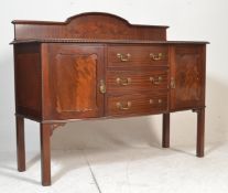 A 1920's mahogany bow front sideboard credenza, Raised on squared legs with pad feet. Above, a bow