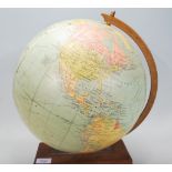 A retro 20th Century desk top Philips 12 Inch Terrestrial globe with 12 gores, raised on a wooden