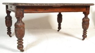 A large Victorian 19th century oak dining table. Raised on bulbous cup and cover legs with ceramic