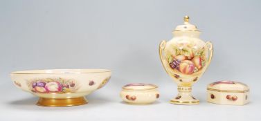 A selection of Aynsley Orchard Gold pattern ceramics printed with peaches and grapes on a yellow