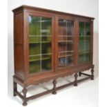 An early 20th Century large oak  Edwardian  triple library bookcase on stand. The bookcase with