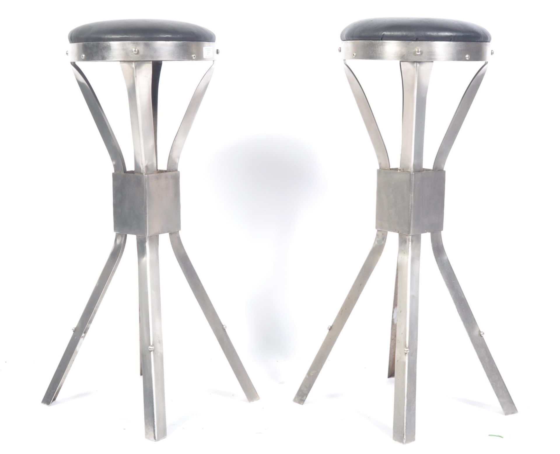 A pair of 20th Century retro vintage industrial workbench / bar stools of polished metal