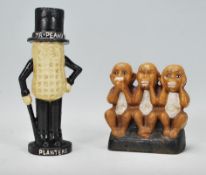 Two novelty vintage style cast iron money banks to include one in the design of The Three Monkeys