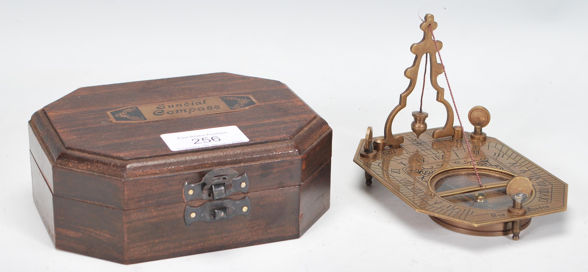 A 20th Century cased brass Sundial Compass, the compass set within the folding metamorphic