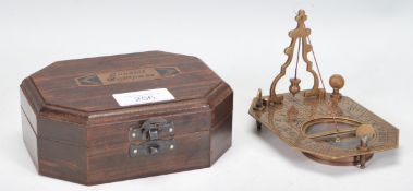 A 20th Century cased brass Sundial Compass, the compass set within the folding metamorphic