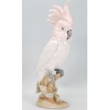 A 20th Century Royal Dux ceramic figurine in the form of a parrot / cockatoo having white and pink