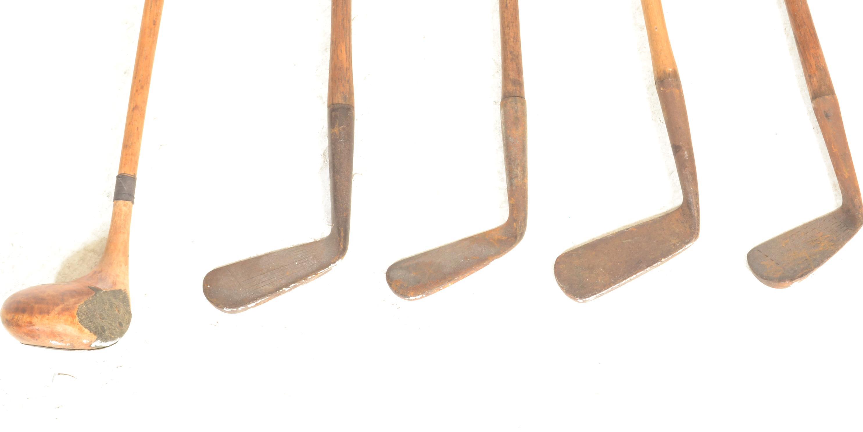 A group of early 20th Century golf clubs having wooden shafts with cast metal heads to include irons - Image 4 of 5