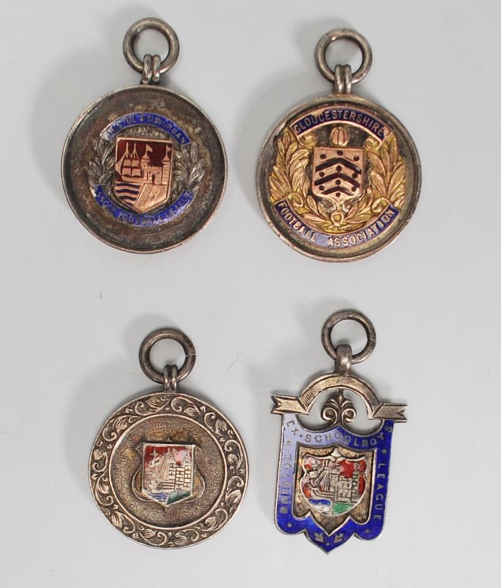 A group of four silver hallmarked early 20th Century Art Deco 1920's fob medals to incldue