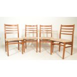 A set of four retro 20th Century teak wood rail back dining chairs, upholstered seat pads raised