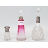 A group of three 19th Century Victorian dressing table perfume bottles, to include a pink glass