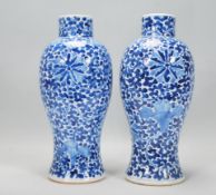 A pair of late 19th Century / early 20th Century Chinese blue and white vases having hand painted