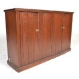 A Victorian 19th century stained pine church vestry cabinet cupboard raised on a plinth base with