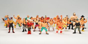 A collection of 1990's toy Titan sports wrestling action figures to include a wide selection of