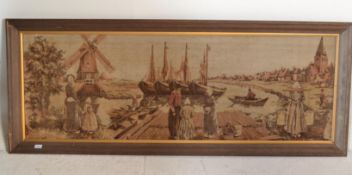 A mid century large framed tapestry needlepoint depicting a dutch / flemish scene. Inset to a good