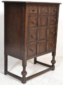 A Queen Anne revival oak chest of drawers on stand. Raised on cup and cover legs with peripheral