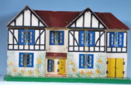 A vintage childrens circa 1950's dolls house of wooden painted construction having double opening