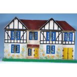 A vintage childrens circa 1950's dolls house of wooden painted construction having double opening