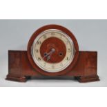 A 1930's Art Deco walnut mantel clock with silvered chapter ring, faceted hands set within an