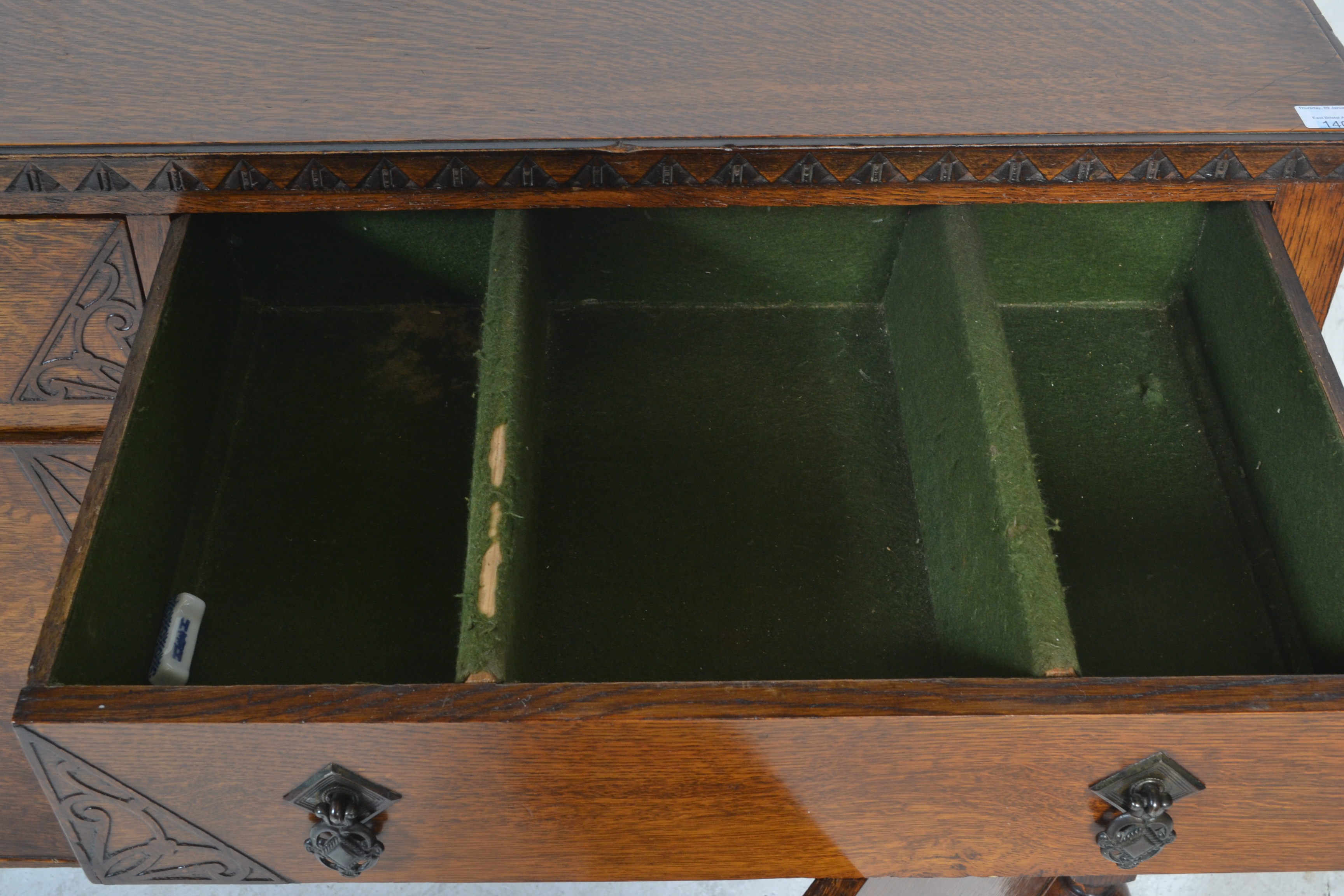 A 1930's oak sideboard being raised on cup and cover legs having twin cupboard doors under short - Image 5 of 6