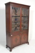 A Regency revival mahogany library bookcase cabinet. Raised on cabriole carved legs with pad feet