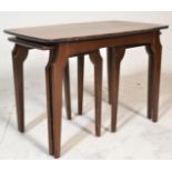 A mid century, circa 1950's teak wood and walnut inlaid graduating nest of tables. Raised on