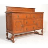 An early 20th Century block fronted oak sideboard credenza having a configuration of cupboards and