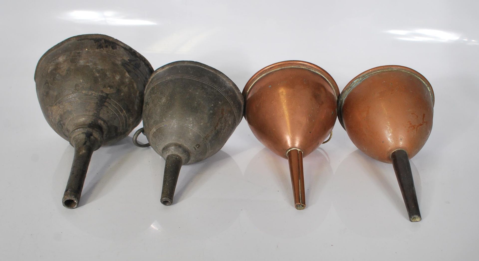 Two 19th Century Georgian wine funnels. One being pewter and the other lead with both having similar