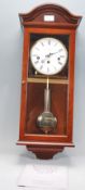 A good solid mahogany cased  Comitti of London strike and chime wall clock. The roman numeral