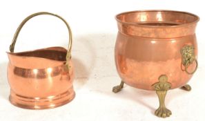 A late 19th / early 20th Century copper coal scuttle raised on a stepped base with a brass swing