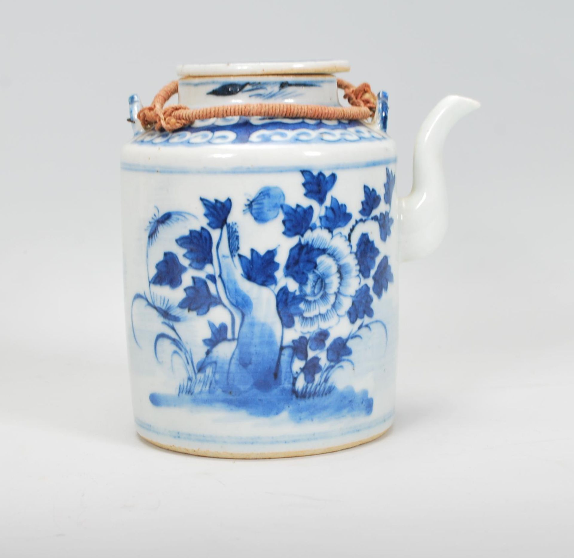 A 19th Century Chinese porcelain tea pot of tubular form hand painted in blue and white with peonies - Image 3 of 7