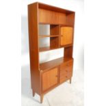 A retro mid 20th Century teak wood room unit having fitted shelves above a configuration of three