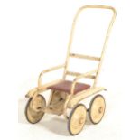 A vintage 20th Century child's doll / bear push along chair of metal tubular construction finished