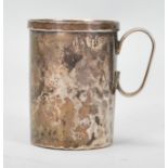 A 20th Century 800 silver Christening mug of small proportions having a hammered finish and lip to