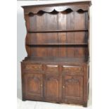 A 17th century style joined and moulded oak dresser, having two-tier open plate rack, three