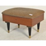 A retro mid century, circa 1950's teak wood and upholstered foot stool sewing box. The upholstered