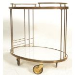 A 1950's retro vintage brass and laminate two tier serving / drinks / cocktail trolley having a