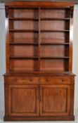 A 19th century Victorian mahogany library bookcase cabinet having twin door cupboard base with two
