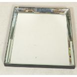 A 20th Century wall mirror of rectangular form having bevelled glass with an angular form mirror