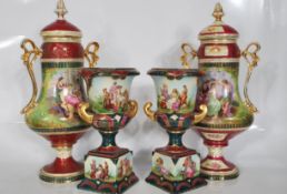 A matching pair of early 20th Century Continental twin handled ceramic urn vase having burgundy